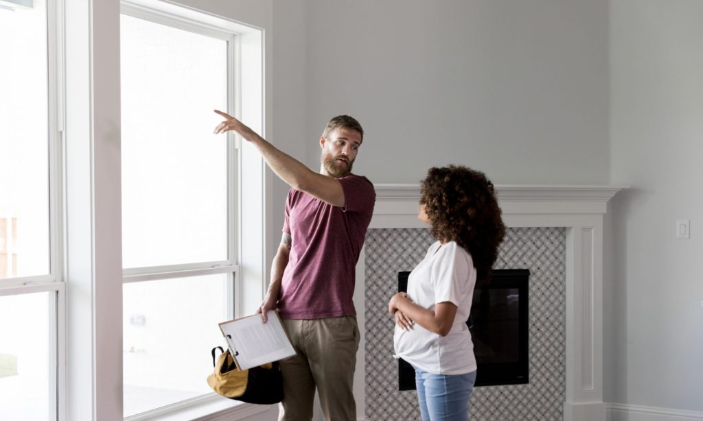 Home Inspector pointing out report for new home buyer